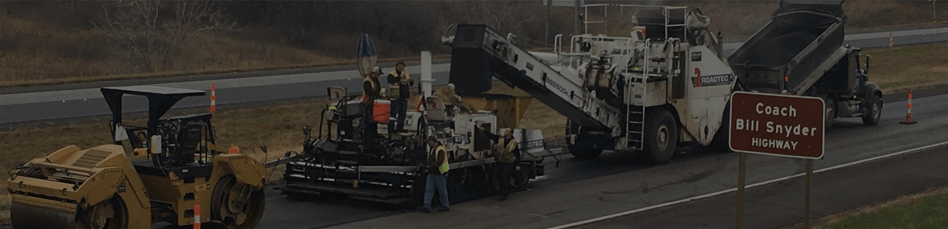 photo of paving operation in-progress on coach bill snyder highway